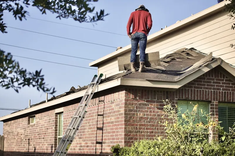 Professional roofer working on a residential roof in Westwood Village